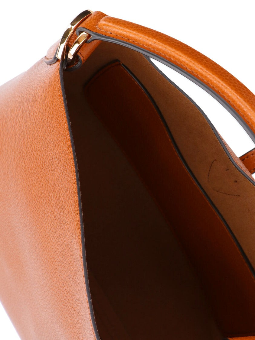Tod's Brown Textured Leather Bucket Bag With Adjustable Strap And Gold-Tone Logo